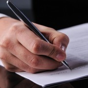 businessman writing on a form