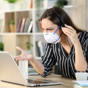 Angry telemarketer checking laptop avoiding coronavirus