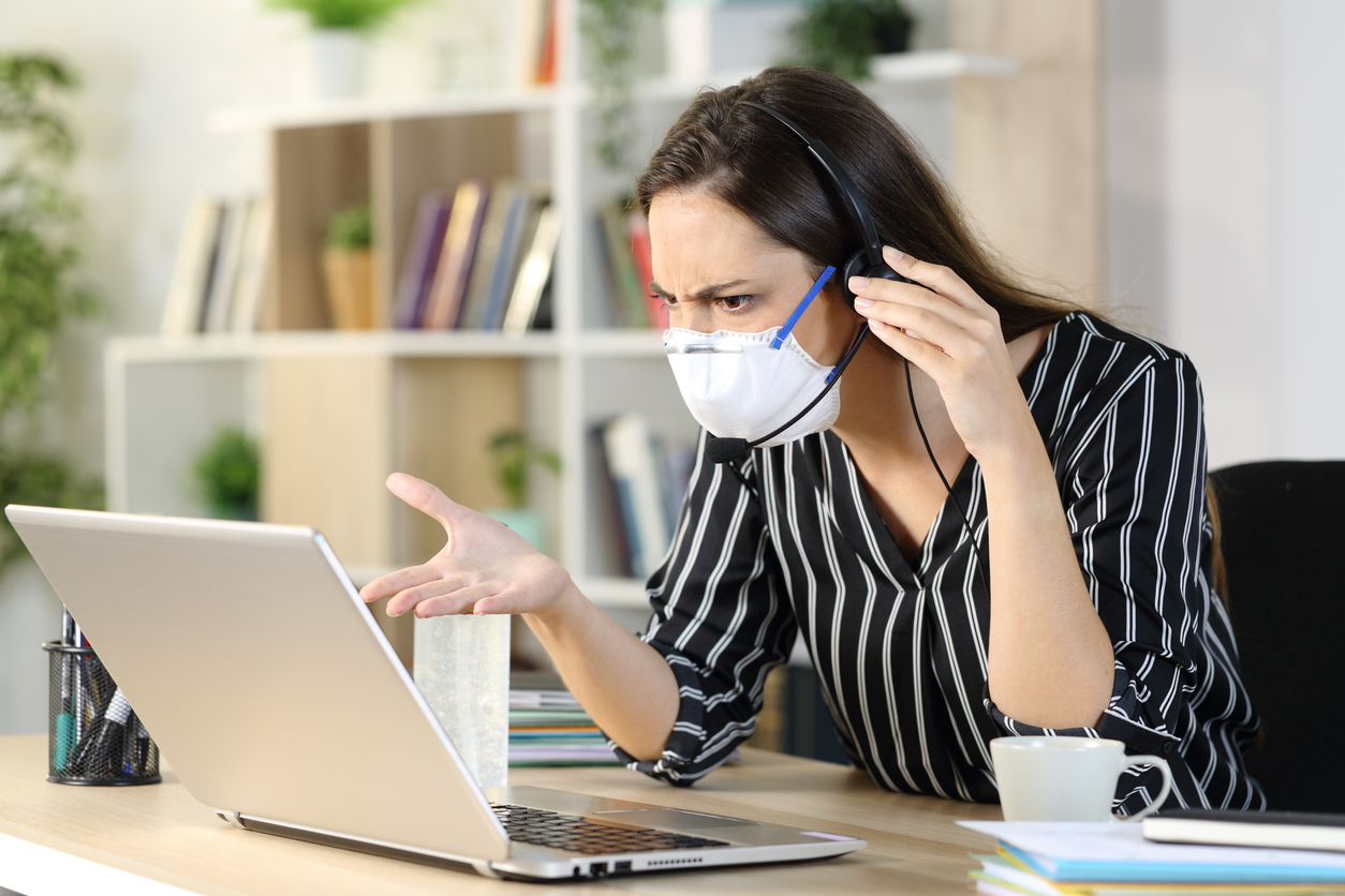 Angry telemarketer checking laptop avoiding coronavirus